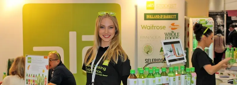 Hostess at a soft drinks brand stand at a trade show