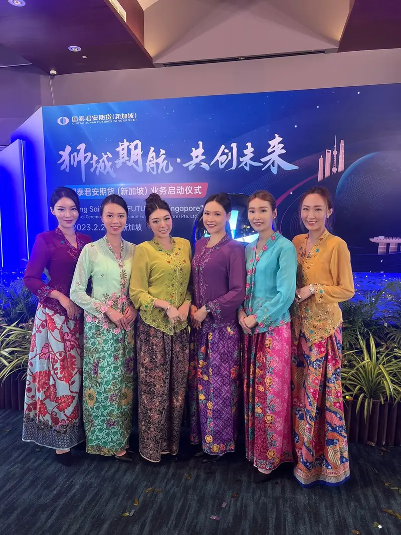 Six welcome hostesses in traditional kebaya outfits at a corporate launch ceremony